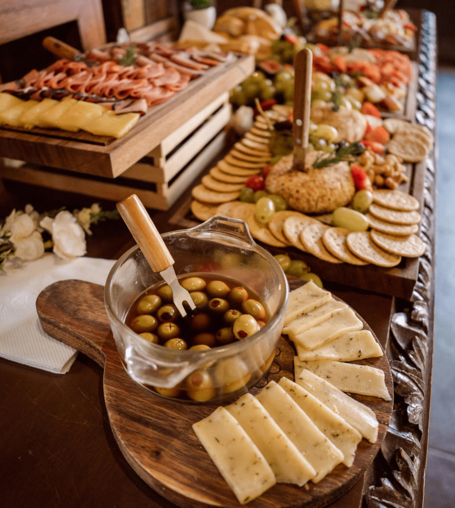Fresh & Exotic charcuterie display with cheeses, crackers, olives, and cured meats
